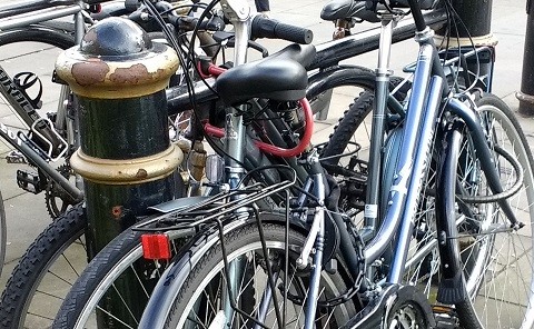 Closeup of bicycles chained to a post