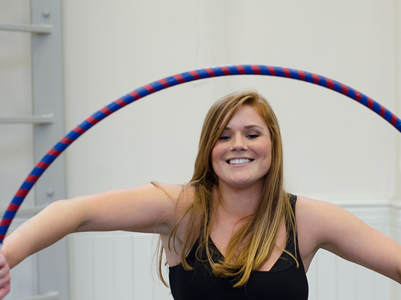 a girl at the workshop tries the hula hoop