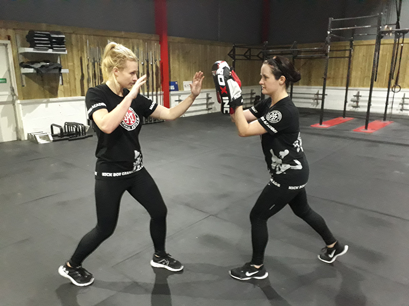 Two women in a fighting stance