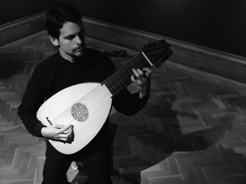 a man playing the lute 