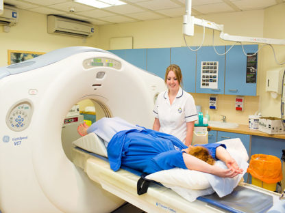 nurse taking a CT scan of a patient