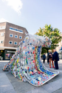 Art display of waste in the shape of a wave