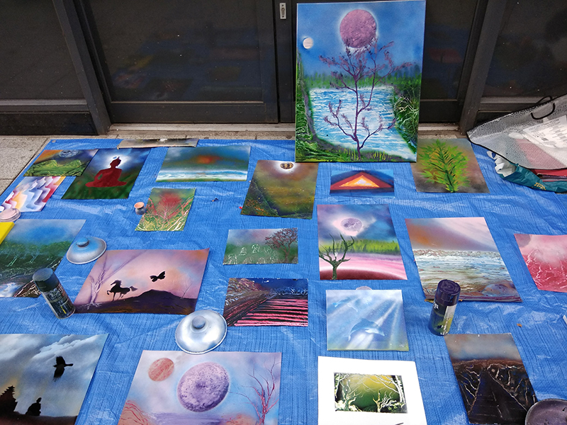 a display of spray paintings on Queen Street