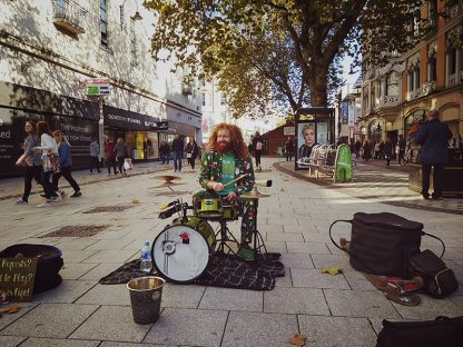 A busker, Cliff Collings, at his drum set on Queen Street
