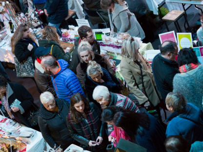 a busy crowd looking at stalls