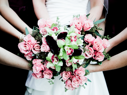 Flowers being held by many hands