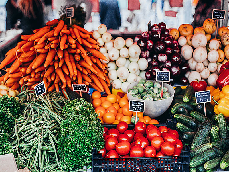 stand of vegetables. colourful tomatoes peppers green beans