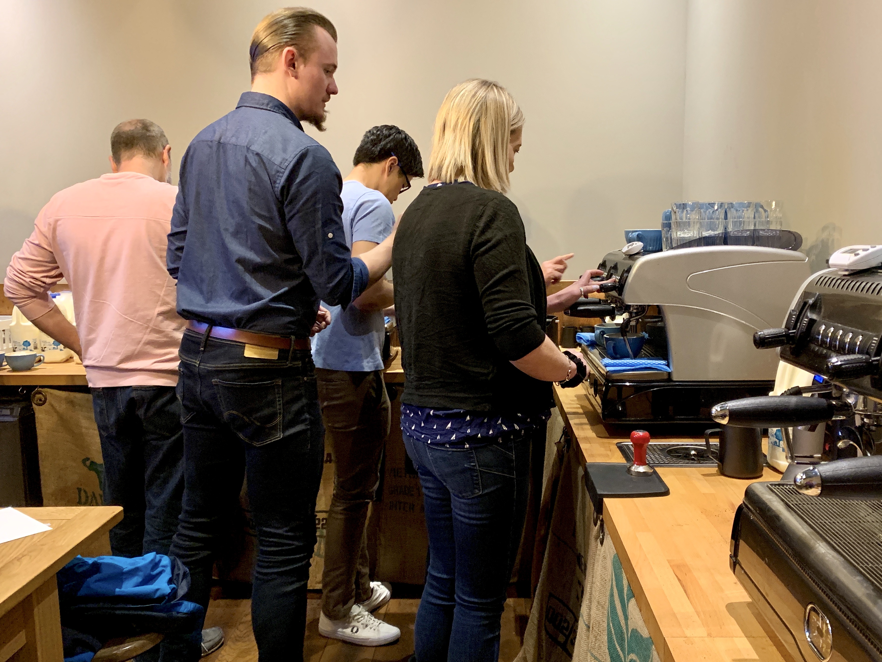 Barista school in progress - people learning to make coffee