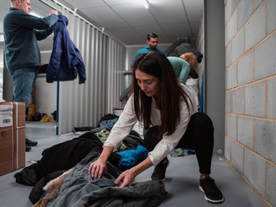 volunteers sort through donations of coats for the Wrap Up campaign