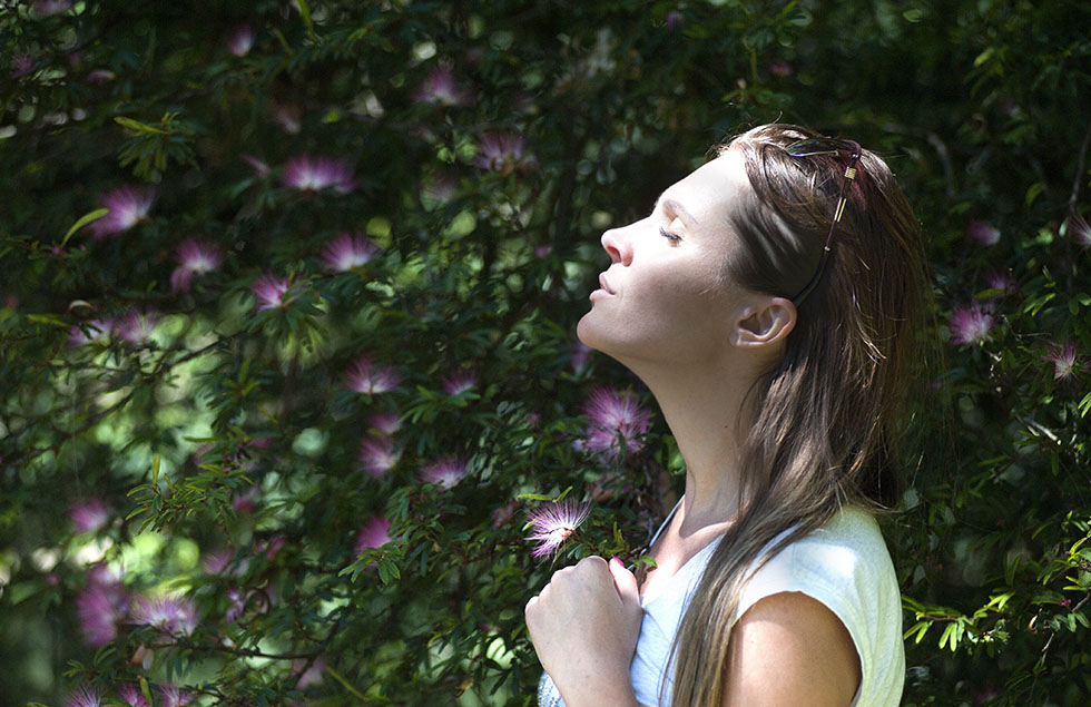 Women stands in sun, looking calm