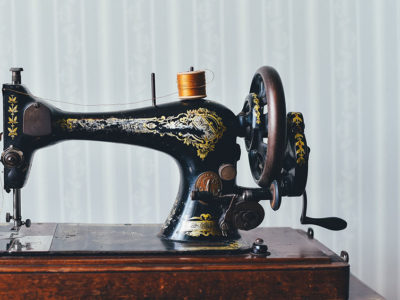 black and gold sewing machine on wooden table