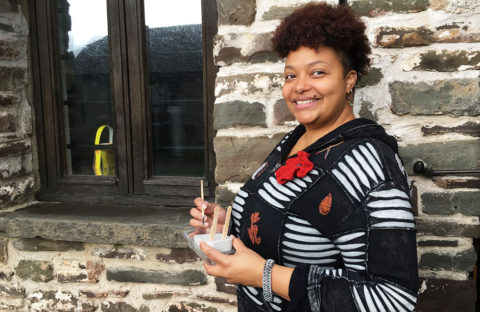 Princes Trust winner Natasha Graves stands outside her art workshop holding one of her concrete moulds for painting