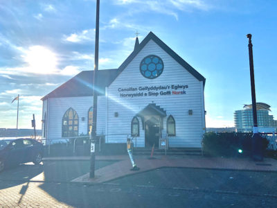 The sun shines behind the Norwegian Church Arts Centre