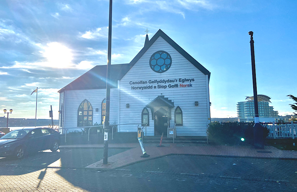 The sun shines behind the Norwegian Church Arts Centre