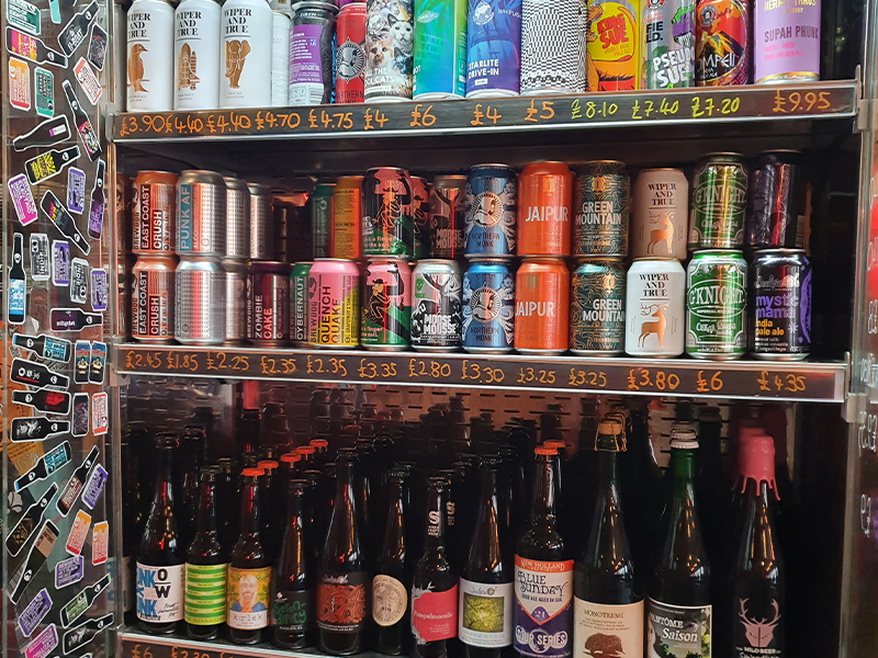 A colourful fridge filled with cans and bottles of craft beers at BrewDog in Cardiff during the Month of Darkness.