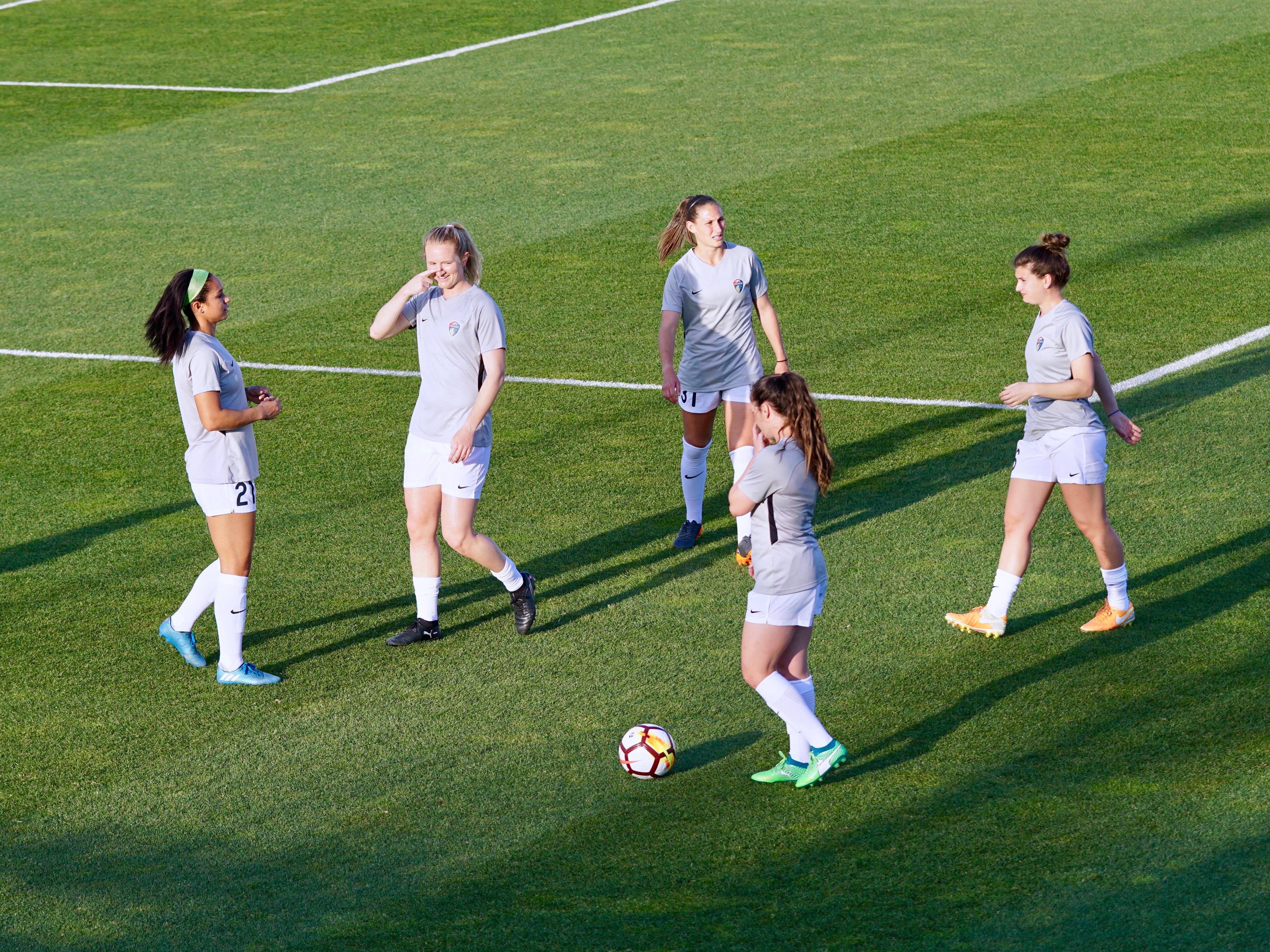 Girls playing football on a pitch