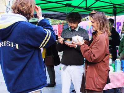 Group of people share free vegan food on Green Friday