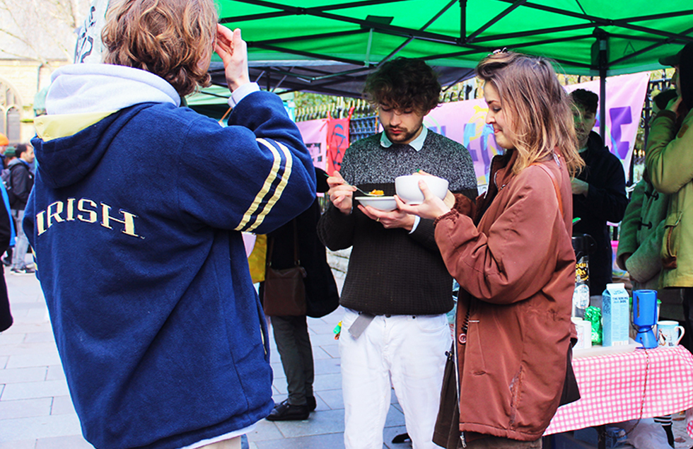 Group of people share free vegan food on Green Friday