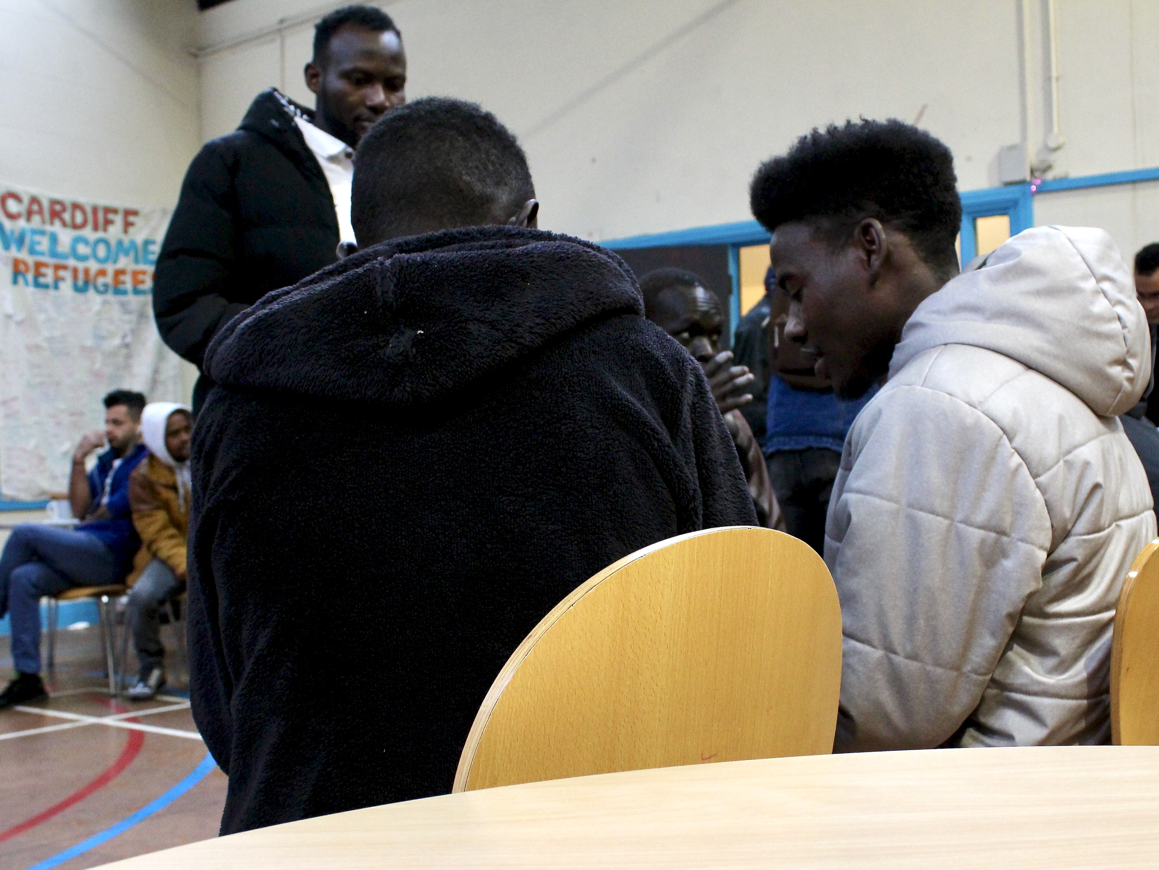 Men sitting/standing and talking