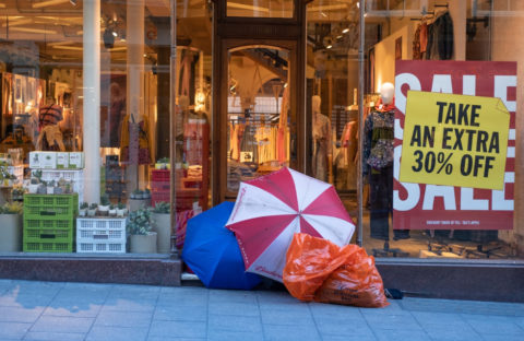 Homeless man sat outside of shop