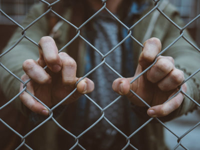 Prisoner behind a fence