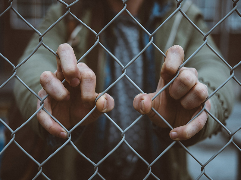 Prisoner behind a fence