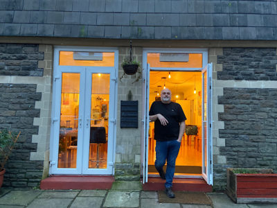 Mark Lewis stands in the open doorway of the City United Reform Church cafe