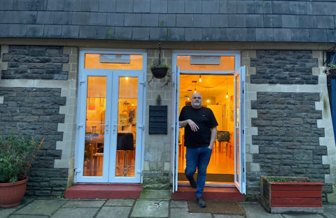 Mark Lewis stands in the open doorway of the City United Reform Church cafe