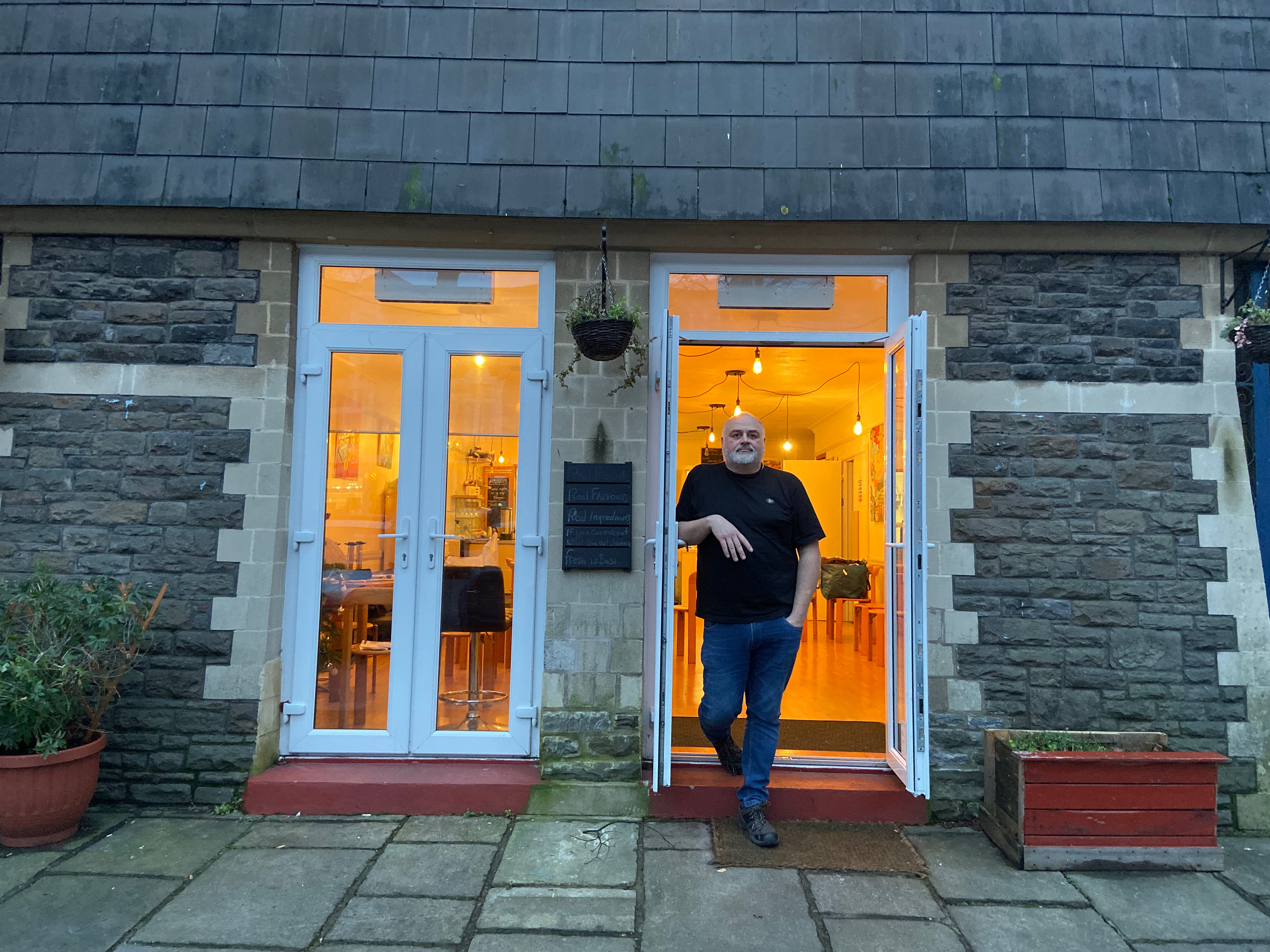 Mark Lewis stands in the open doorway of the City United Reform Church cafe where the LGBT+ refugee support group runs