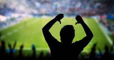 Man Raising Arms at Sporting Event