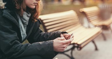 Teenage girl feeling depressed, using a smartphone