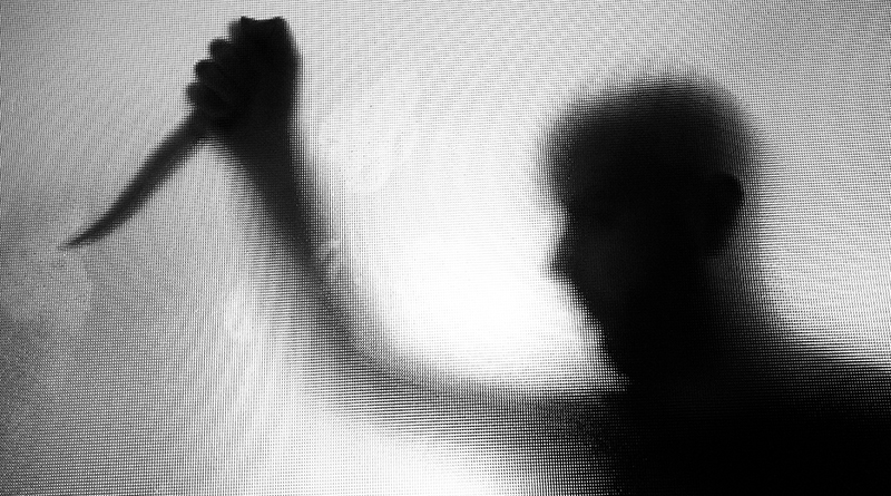 threatening silhouette of man wielding a knife