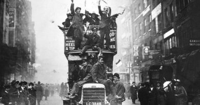 People celebrate the end of war on a London bus