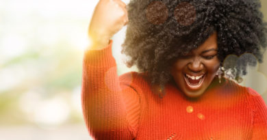 A woman expressing a winning gesture